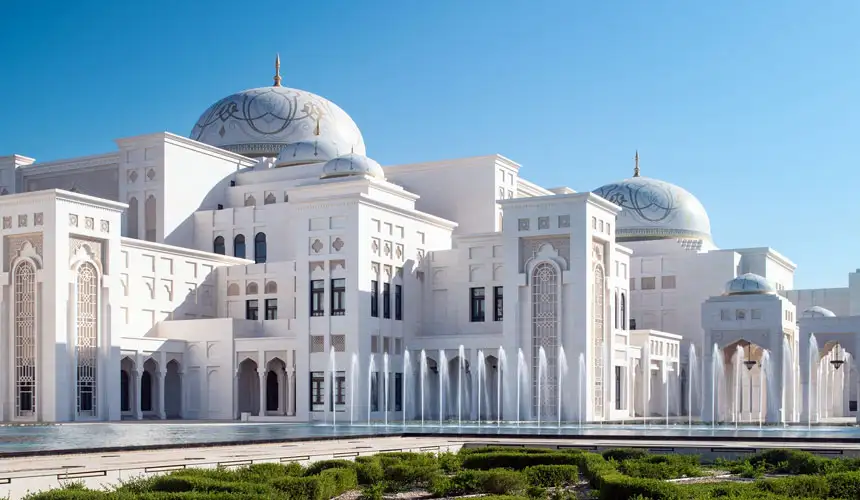 Stunning view of Qasr Al Watan presidential palace in Abu Dhabi featuring white domes, intricate arches, and cascading fountains against a bright blue sky.